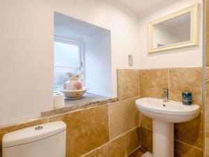 a bathroom with a sink and a toilet and a window at 2 Bed in York oc-91049 in Kirkbymoorside +14 photos
