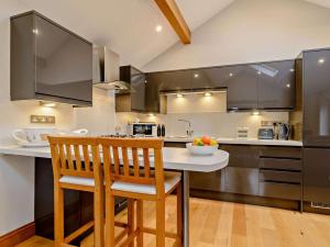 a kitchen with a table and two chairs and a counter at 1 Bed in Halifax oc-90213 in Sowerby Bridge