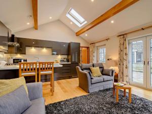 a kitchen and living room with a couch and a table at 1 Bed in Halifax oc-90213 in Sowerby Bridge