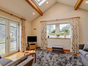 a living room with a couch and a tv at 1 Bed in Halifax oc-90213 in Sowerby Bridge +2 photos