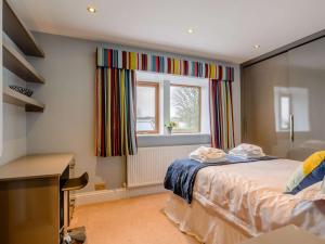 a bedroom with a bed and a window at 3 Bed in Halifax oc-90209 in Sowerby Bridge
