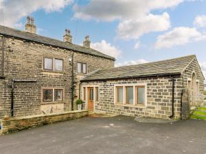 a brick house with a parking lot in front of it at 3 Bed in Halifax oc-90209 in Sowerby Bridge
