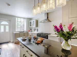 a kitchen with a vase of flowers on a counter at 2 Bed in Harrogate oc-88933 in Pateley Bridge +7 photos