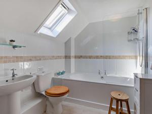 a bathroom with a tub and a toilet and a sink at 3 Bed in Bude oc-trvvv in Poughill +18 photos