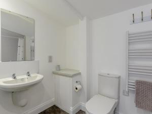 a white bathroom with a toilet and a sink at 1 Bed in Weymouth oc-78865 in Weymouth +10 photos