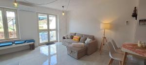 a living room with a couch and a table at Casa Blu Mare privat beach 9 person in San Nicola Arcella
