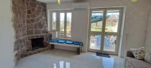a living room with a stone fireplace and a couch at Casa Blu Mare privat beach 9 person in San Nicola Arcella