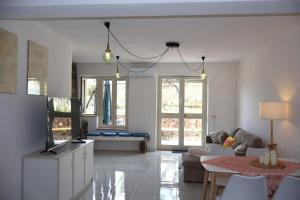 a living room with a couch and a table at Casa Blu Mare privat beach 9 person in San Nicola Arcella