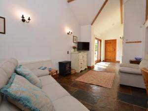 a living room with a white couch and a television at 2 Bed in Sherborne oc-folki in Long Burton