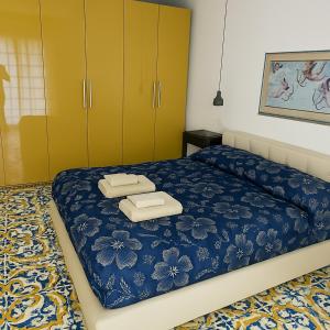 a bedroom with a bed with two towels on it at Villetta Ninì in Ischia Town
