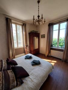 a bedroom with a large bed with two pillows on it at Renard et l'abeille in Chalmoux +92 photos