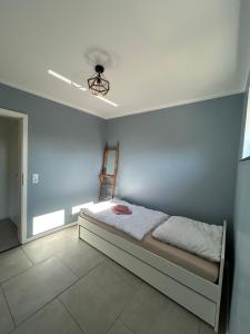 a bedroom with a bed and a ceiling fan at Well-being in Eifel in Nettersheim