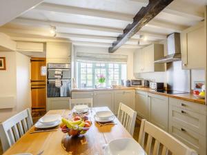 a kitchen with a table with a bowl of fruit on it at 2 Bed in Harmby Nr Leyburn oc-g0136 in Hornby
