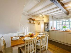 a kitchen and dining room with a wooden table and chairs at 2 Bed in Harmby Nr Leyburn oc-g0136 in Hornby +15 photos