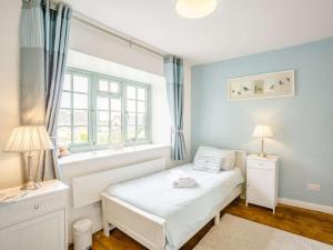 a bedroom with a white bed and a window at 2 Bed in Harmby Nr Leyburn oc-g0136 in Hornby