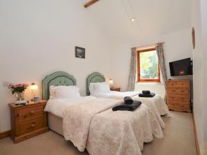 a bedroom with two beds and a television in it at 2 Bed in Sherborne oc-folwo in Long Burton +17 photos