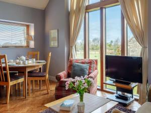 a living room with a television and a dining room table at 2 Bed in Radstock oc-00452 in Binegar