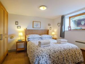 a bedroom with a bed with two pillows on it at 2 Bed in Radstock oc-00452 in Binegar