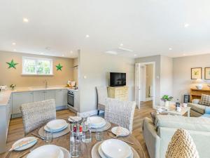 a kitchen and living room with a table and chairs at 2 Bed in York oc-84001 in Crayke