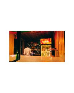 a man sitting at a bar in a restaurant at Hôtel Saint Jean Leopold in Kigali