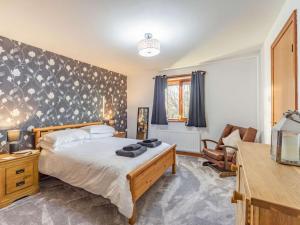 a bedroom with a bed and a chair at 4 Bed in Morpeth oc-86132 in Warkworth