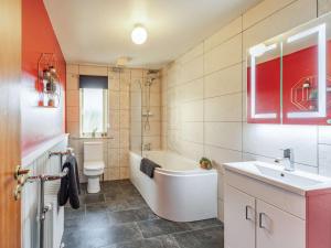 a bathroom with a tub and a sink and a toilet at 4 Bed in Morpeth oc-86132 in Warkworth +15 photos