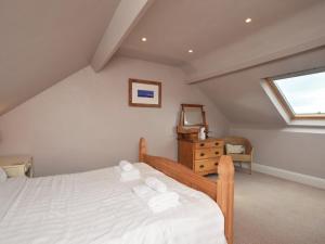 a bedroom with a bed with white sheets and a window at 3 Bed in Morpeth oc-cn137 in Amble