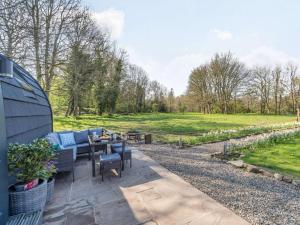 a patio with a couch and a table in a field at 1 Bed in Consett oc-87934 in Shotley Bridge