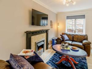 a living room with couches and a fireplace at 2 Bed in Ripon oc-88051 in Ripon