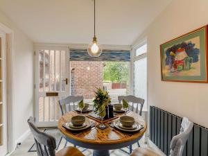 a dining room with a wooden table and chairs at 2 Bed in Ripon oc-88051 in Ripon