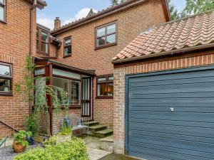 a brick house with a blue garage door at 2 Bed in Ripon oc-88051 in Ripon