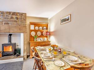 a dining room with a table and a fireplace at 2 Bed in Hexham oc-50500 in Bellingham