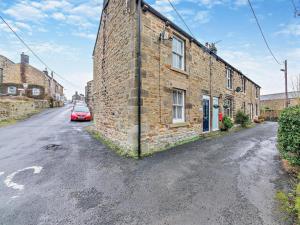 a brick building with a car parked next to it at 2 Bed in Hexham oc-50500 in Bellingham