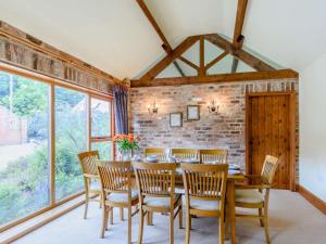 a dining room with a wooden table and chairs at 3 Bed in York oc-83264 in High Catton