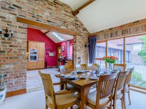 a dining room with a wooden table and chairs at 3 Bed in York oc-83264 in High Catton +15 photos