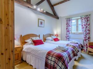 a bedroom with two beds and a window at 3 Bed in York oc-83264 in High Catton