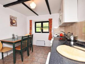a kitchen with a table and a counter top at 2 Bed in Bridgwater oc-alden in Kilve