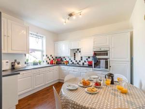 a white kitchen with a table with food on it at 3 Bed in Harrogate oc-hh056 in Harrogate