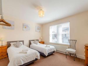 a bedroom with two beds and a window at 3 Bed in Harrogate oc-hh056 in Harrogate