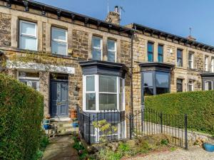 an old brick house with a gate and bushes at 3 Bed in Harrogate oc-hh056 in Harrogate