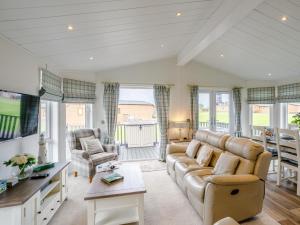a living room with a couch and a table at 2 Bed in Bridlington oc-79429 in Sewerby