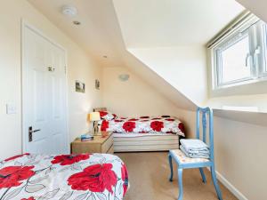 a attic bedroom with a bed and a window at 3 Bed in Yeovil oc-htorv in Castle Cary