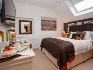 a bedroom with a bed and a table with food on it at 2 Bed in Harrogate oc-75642 in Summer Bridge