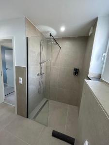 a shower with a glass door in a bathroom at Well-being in Eifel in Nettersheim +19 photos