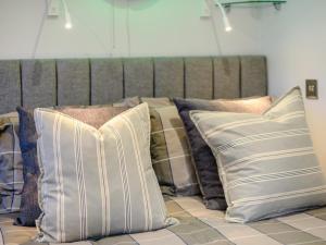 a pile of pillows sitting on top of a couch at 1 Bed in Christchurch oc-90444 in Highcliffe