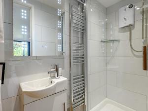 a white bathroom with a sink and a shower at 1 Bed in Christchurch oc-90444 in Highcliffe +6 photos