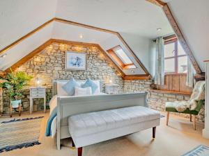 a bedroom with a bed and a stone wall at 1 Bed in Wedmore oc-51340 in Chapel Allerton