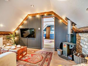 a living room with a fireplace and a wood stove at 1 Bed in Wedmore oc-51340 in Chapel Allerton
