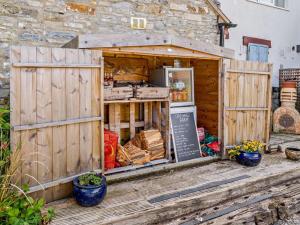 a wooden building with a food stand on a deck at 1 Bed in Wedmore oc-51340 in Chapel Allerton +15 photos