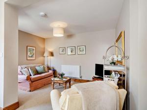 a living room with a couch and a table at 1 Bed in York oc-84002 in Crayke